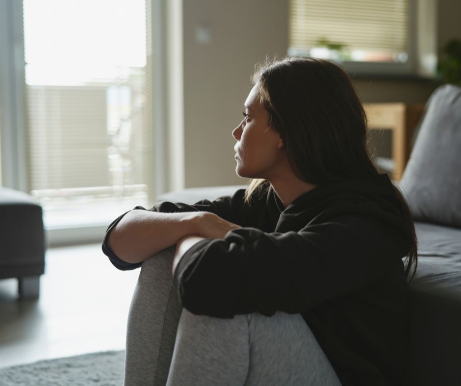 Young woman looking out window