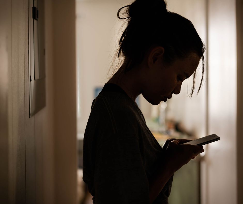 Woman texting in hallway