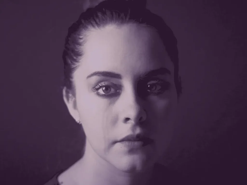 monotone image of woman with tear stained face