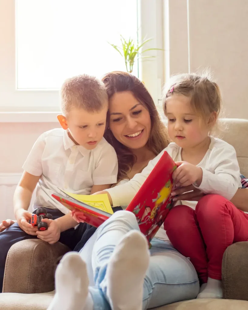 Mother with two children sitting together reading