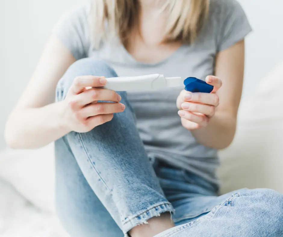 woman holding a pregnancy test